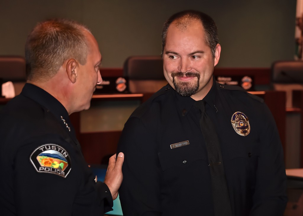 Tustin PD Chaplain Jack Mumford, right, is welcomed by Tustin Police Chief Charles Celano during a promotions ceremony. Photo by Steven Georges/Behind the Badge OC