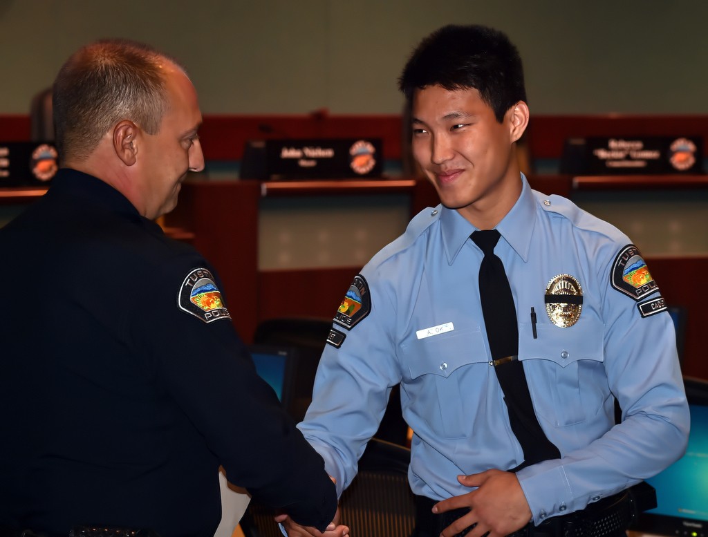 Tustin PD Cadet Andrew Ok is greeted by Tustin Police Chief Charles Celano during a promotions ceremony. Ok plans on attending the police academy once he graduates from UCI. Photo by Steven Georges/Behind the Badge OC