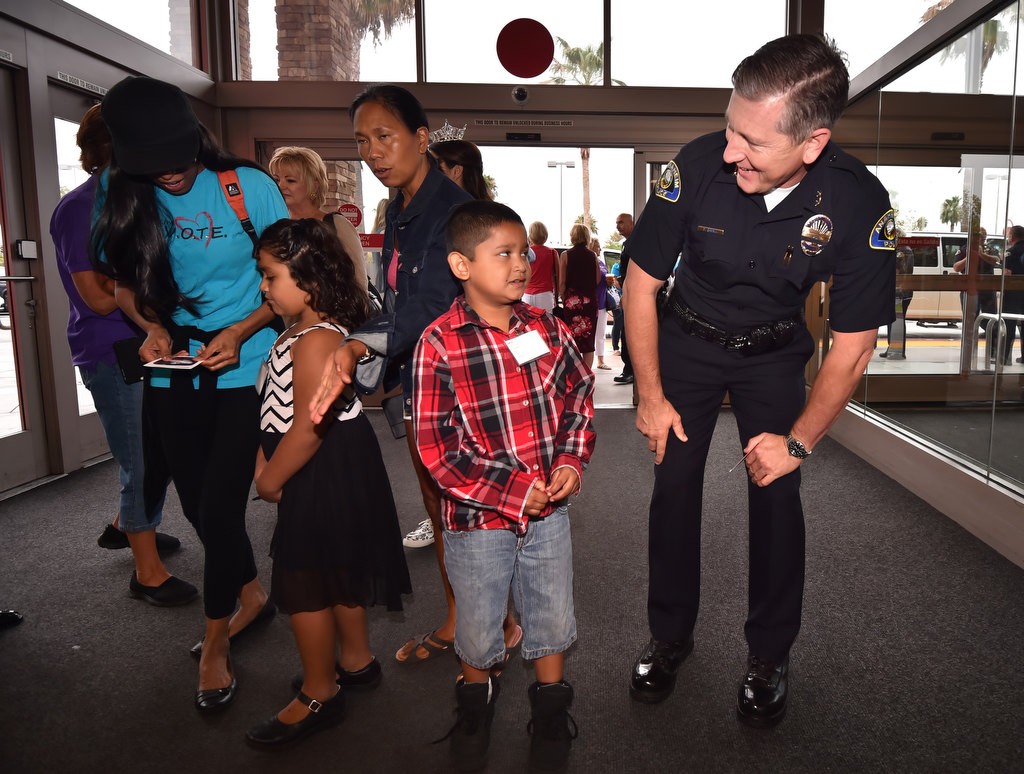 Anaheim PD Deputy Chief Dan Cahill partners up with 7-year-old Aaron as they enter Target for the start of their Back-to-School shopping. Photo by Steven Georges/Behind the Badge OC