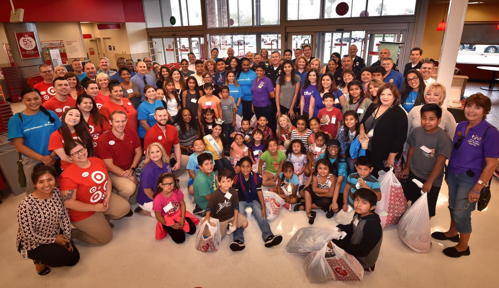Kids from OCFJC Foundation’s sixth annual Back-to-School Program, the Anaheim PD, OCFJC members, Target employees and volunteers gather for a group photo at the conclusion of a back to school shopping spree at the Target in Anaheim. Photo by Steven Georges/Behind the Badge OC