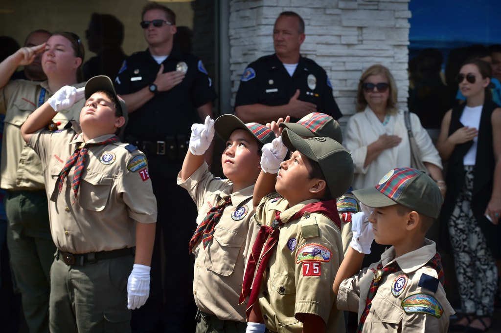Boy Scouts from local troop 75 salute during the morning flag raising ceremony for the grand re-opening of the Valley View McDonald’s. Photo by Steven Georges/Behind the Badge OC