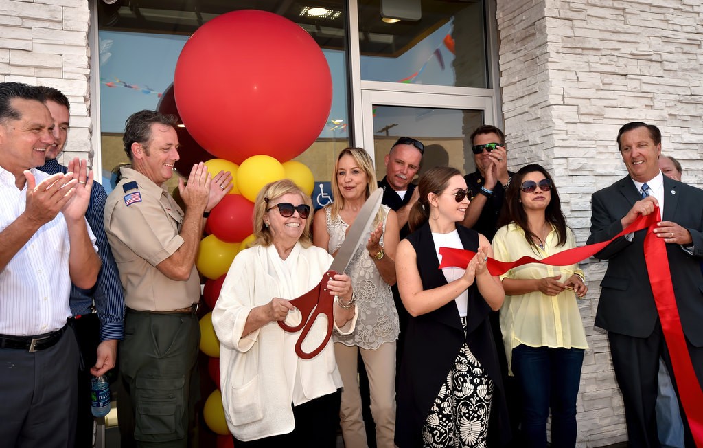 A smiling Patti Widdicombe, with scissors, and Sam Widdecombe of the family owned Valley View McDonald’s in Garden Grove, cuts the ribbon for the grand re-opening. Behind them is Garden Grove PD Chief Todd Elgin, City Manager Scott Stiles, left, and Council Member Kris Beard holding the ribbon on the right. Photo by Steven Georges/Behind the Badge OC