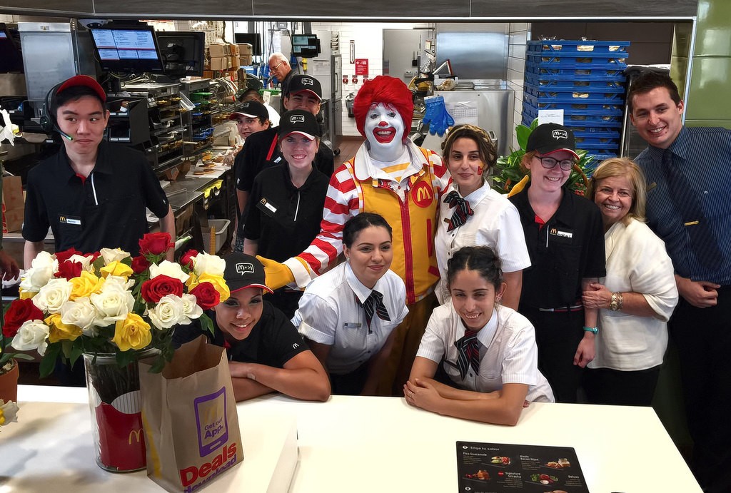 Ronald McDonald with Local McDonald’s Owner/Operator Patti Widdecombe, second from right, and crew during the grand re-opening of the rebuilt McDonald’s on Valley View St. Photo by Steven Georges/Behind the Badge OC