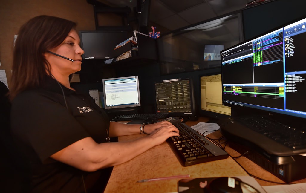 Garden Grove PD Dispatch Supervisor Nicole Shorrow talks calls from the public. Unlike many dispatch centers, Garden Grove doesn’t have a separate radio dispatch station. Each dispatcher is responsible both for taking calls from the public as well as talking to patrol officers. Photo by Steven Georges/Behind the Badge OC