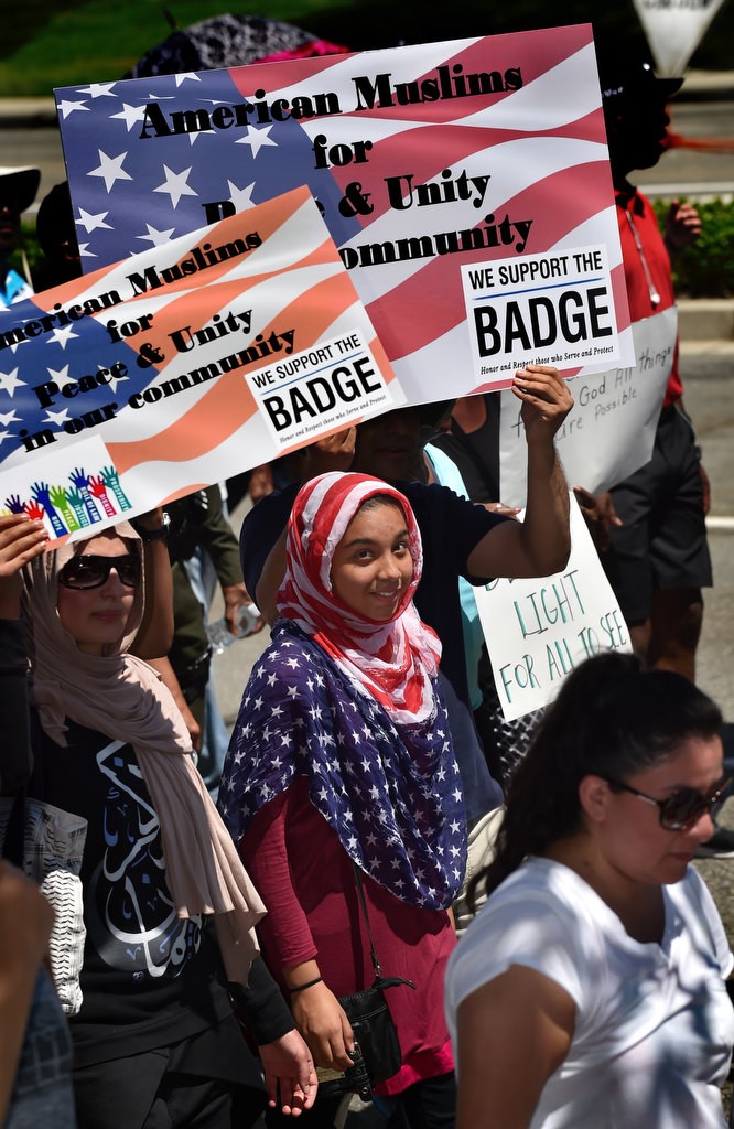 A group of Muslims join others in participating in a solidarity march down Irvine Center Drive. Photo by Steven Georges/Behind the Badge OC