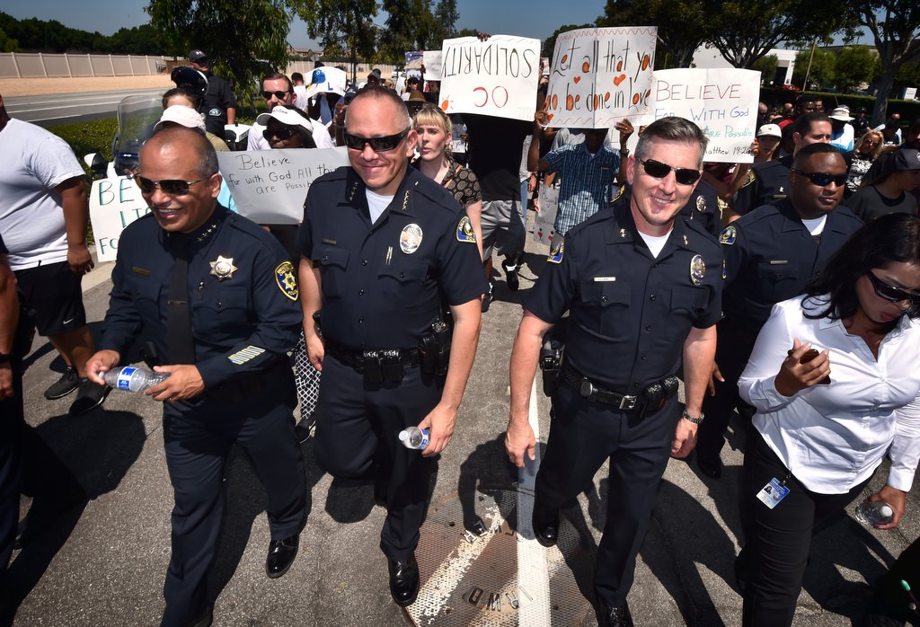 UC Irvine Police Chief Jorge Cisneros, left, Anaheim Police Chief Raul Quezada and APD Deputy Chief Dan Cahill walk down Irvine Center Dr. in a solidarity march. Photo by Steven Georges/Behind the Badge OC