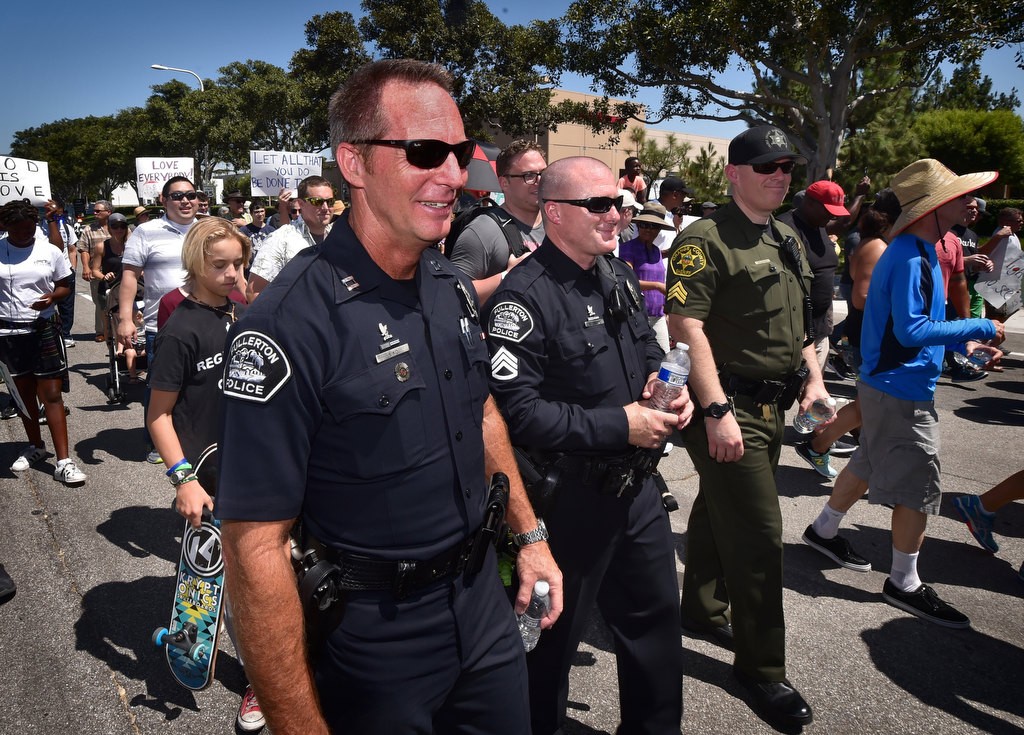 Fullerton PD Captain John Siko, left, and Sgt. Michael Hines join other in walking down Irvine Center Dr. in a solidarity march. Photo by Steven Georges/Behind the Badge OC
