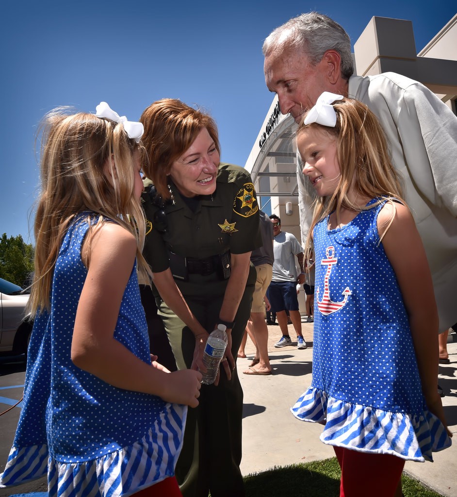 Orange County Sheriff Sandra Hutchens talks to identical twins Olivia and Isabella Webster, 6, who was at the Solidarity March and Action Summit with their grandfather, Doug Webster, a member of the OC Sheriff’s Interfaith Adversity Council. Photo by Steven Georges/Behind the Badge OC