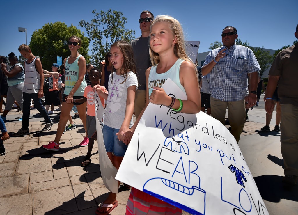 Cora Lawsen, front right, and behind her Reese Townsend, both 8, at the conclusion of a solidarity march. Photo by Steven Georges/Behind the Badge OC