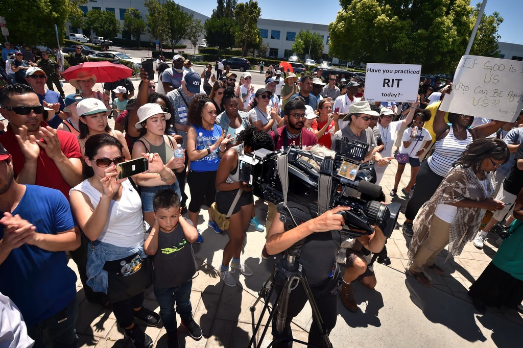 The public and press gather at the conclusion of a solidarity march to hear a few speeches in front of COR (Christ Our Redeemer) Church in Irvine. Photo by Steven Georges/Behind the Badge OC