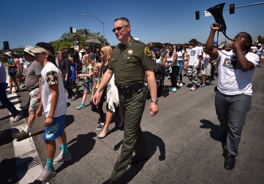 Orange County Undersheriff Don Barnes joins others in walking down Irvine Center Dr. during a solidarity march. Photo by Steven Georges/Behind the Badge OC