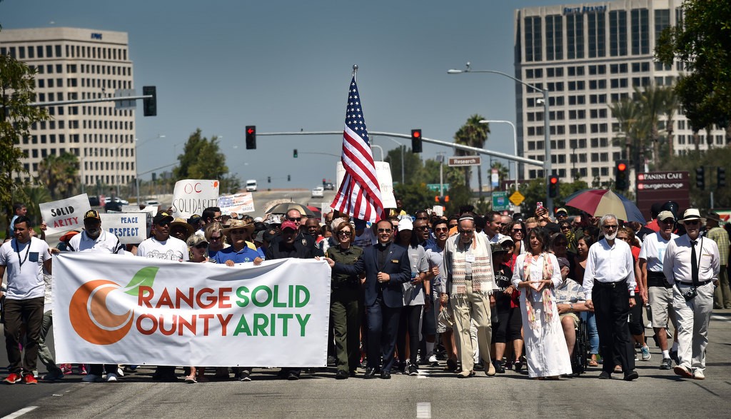 The public along with police and church groups walk down Irvine Center Dr. in a solidarity march. Photo by Steven Georges/Behind the Badge OC