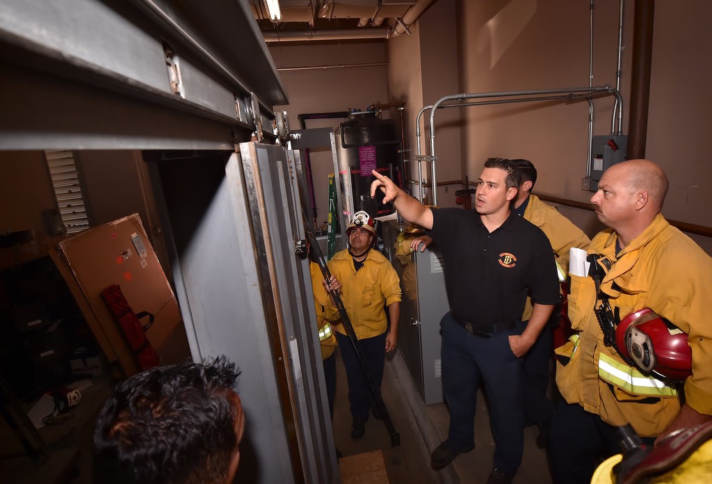 Anaheim Firefighter Mike Houghton (black shirt) instructs a class of firefighters where the door locks are on the inside of an elevator during a elevator rescue training session at Anaheim Fire & Rescue’s headquarters.dge OC