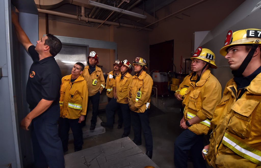 Anaheim Firefighter Mike Houghton, left, instructs a class of firefighters where the door locks are on the inside of an elevator during a elevator rescue training session at Anaheim Fire & Rescue’s headquarters. Photo by Steven Georges/Behind the Badge OC