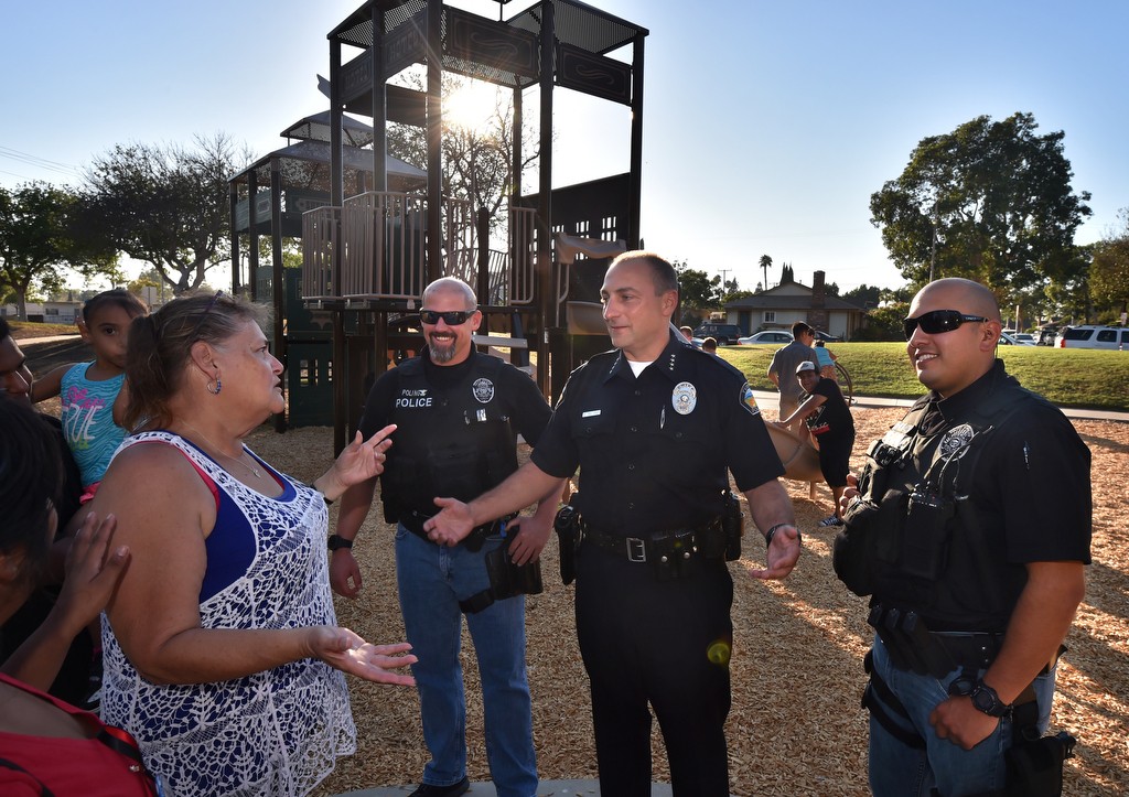 Deborah Carranza, left, mother of Robert Carranza, who was killed in the park a year ago, talks to Tustin Police Chief Charles Celano during the re-dedication of the newer and safer Frontier Park in Tustin. Standing next to the chief are detectives Brian Poling and Ronnie Sandoval, right. Photo by Steven Georges/Behind the Badge OC