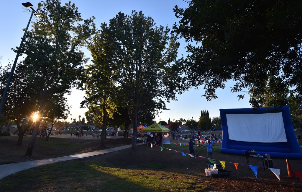 People wait for the sun to go down at the redesigned Frontier Park in Tustin to watch "Kung Fu Panda 3" on the blowup screen, right. Photo by Steven Georges/Behind the Badge OC