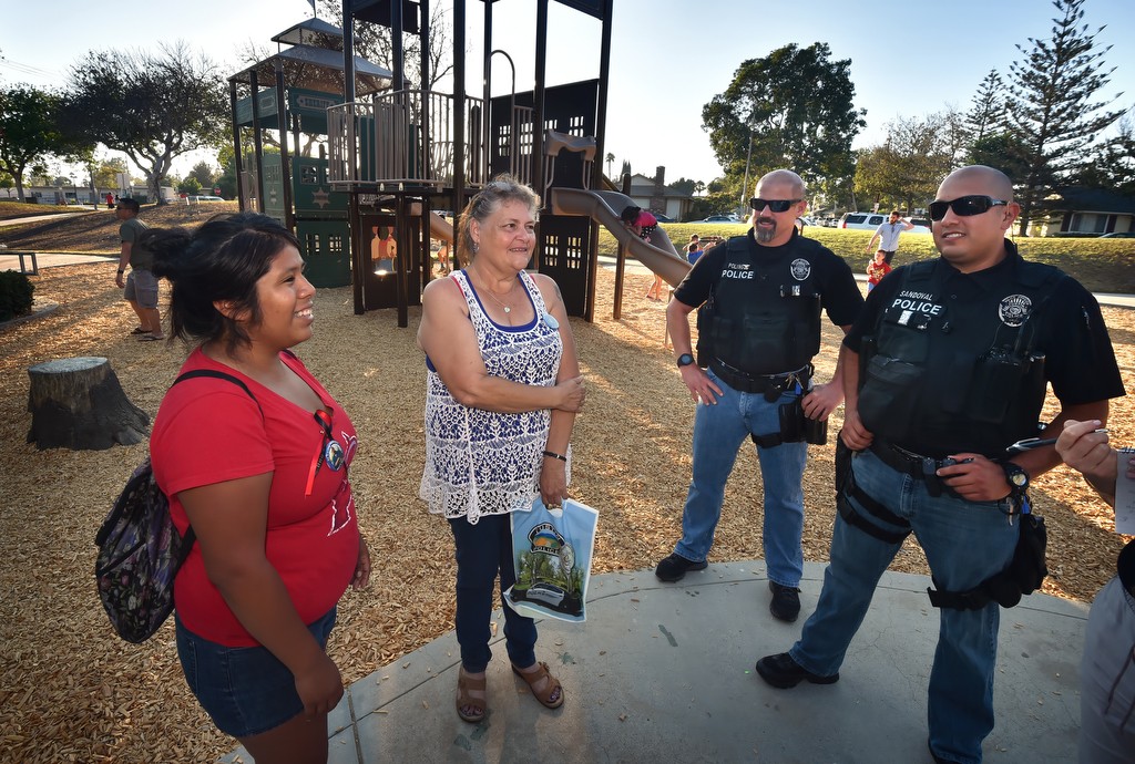 Amanda Cuellar, left, and Deborah Carranza, sister and mother of Robert Carranza who was killed in Frontier Park a year ago, talks to Tustin PD detectives Brian Poling, left, and Ronnie Sandoval who worked on the case. Photo by Steven Georges/Behind the Badge OC