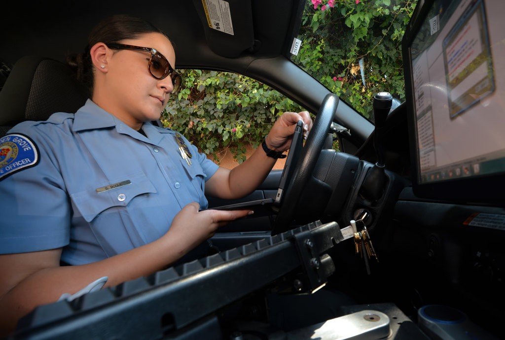 Garden Grove PD CSO Summer Bogue uses uses a portable device to generate a parking ticket while on patrol. Photo by Steven Georges/Behind the Badge OC