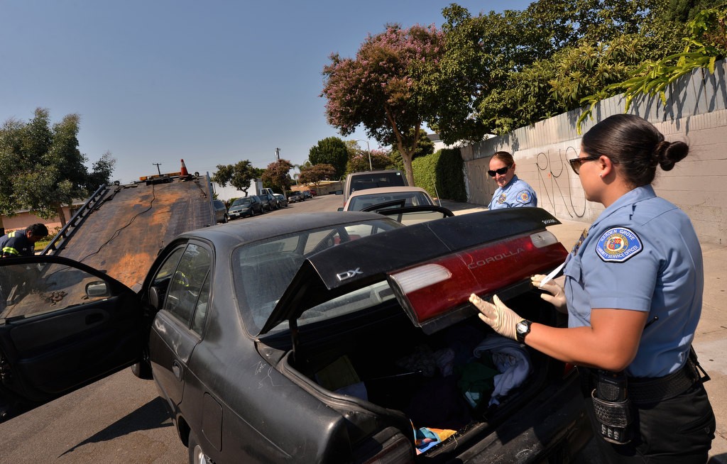 Garden Grove Community Service Officers (CSO) Kari Flood and Summer Bogue, right, conduct an inventory search of a car before it is towed for having an expired plates more than six months old. Photo by Steven Georges/Behind the Badge OC