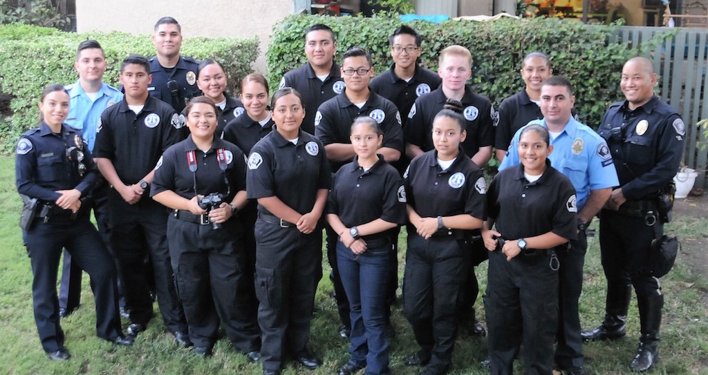 This group of Buena Park Police Department officers and Explorers gathered for a group photo following a volunteer project, in which they relocated the residents of a downstairs apartment into an upstairs unit after the downstairs apartment was burglarized. Photo by Lou Ponsi/Behind the Badge OC