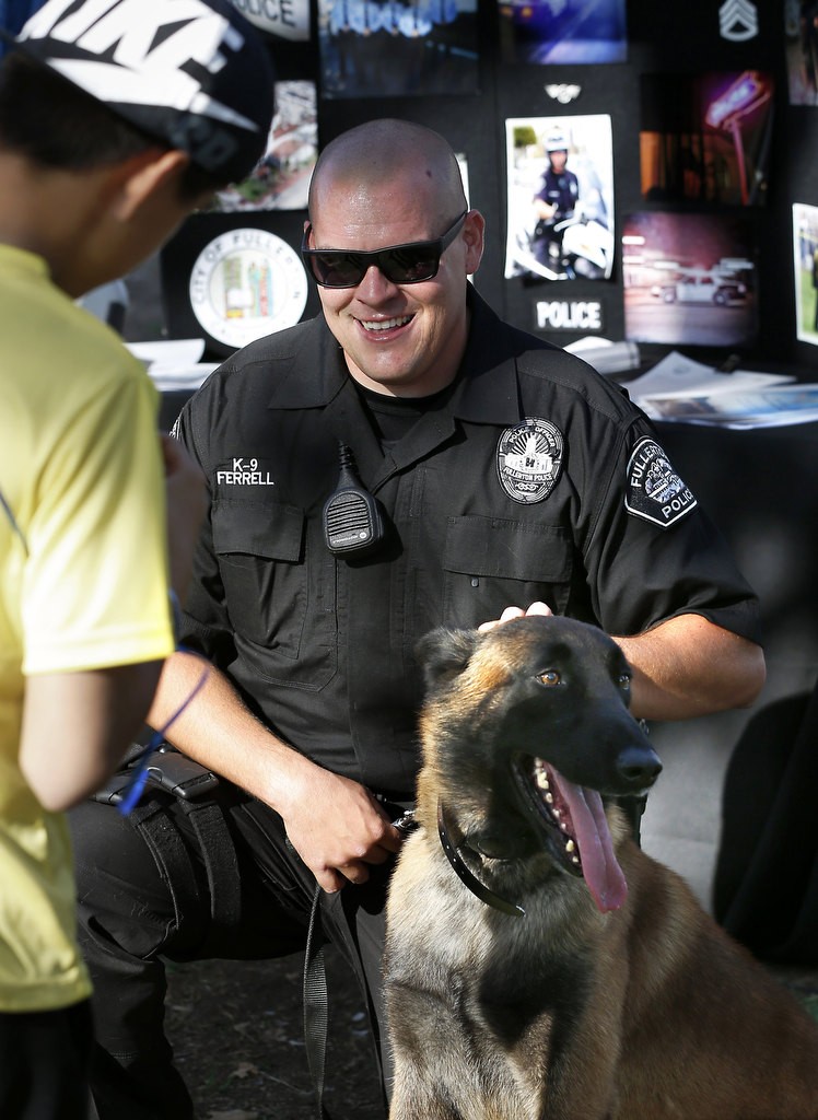 Fullerton PD's Jonathan Ferrell and Rotar pose for a photo during the department's annual National Night Out. Photo by Christine Cotter