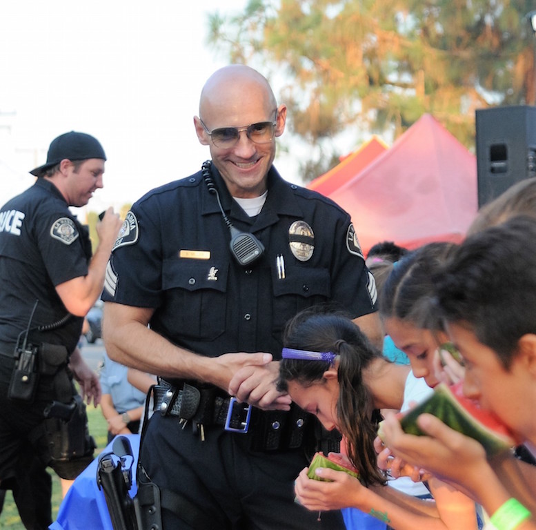 La Habra PD Sergeant Brian Miller seemed to enjoy his role as a judge for the watermelon eating contest at National Night Out, held  Aug. 2 at Portola Park. Photo by Lou Ponsi/Behind the Badge OC 