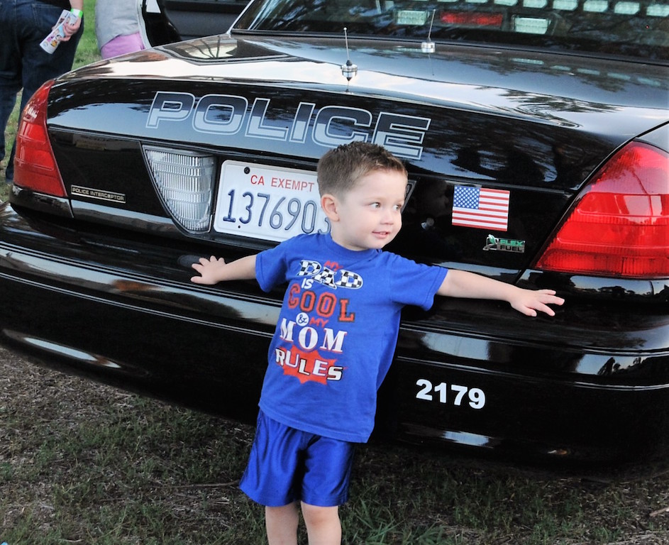  Two-year old Noah poses in front of a La Habra PD patrol car during the National Night Out event held Aug. 2 at Portola Park. Photo by Lou Ponsi/Behind the Badge OC 
