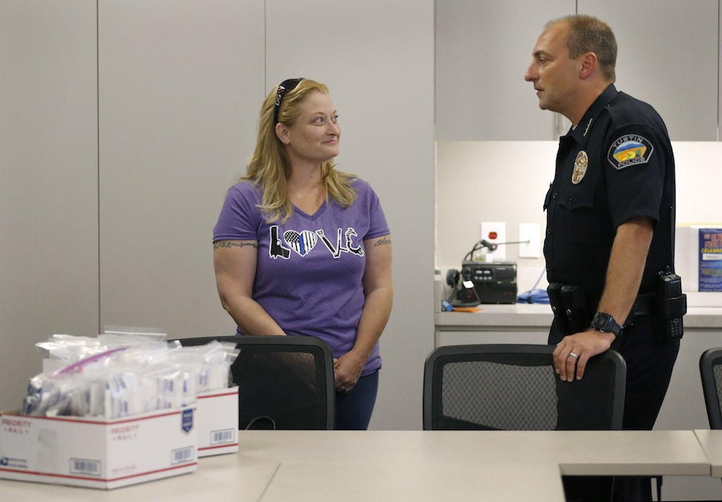 Valerie Mann shows her appreciation to Police Chief Charlie Celano with a donation of boxes filled with snacks, tissues, hygiene products etc. for Tustin Police Department officers. Photo by Christine Cotter/Behind the Badge OC