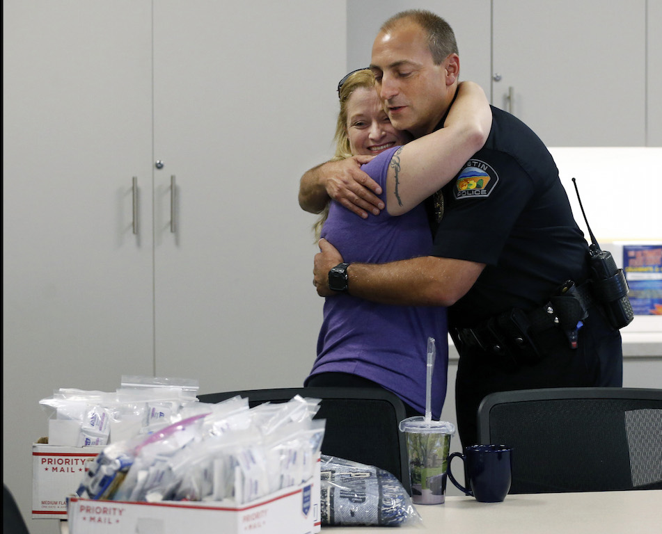 Tustin Police Chief Charlie Celano gives a hug to Valerie Mann who donated snacks, tissues, hygiene products etc. to the Tustin Police Department. Photo by Christine Cotter/Behind the Badge OC  