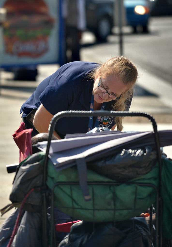 Peg Peterson, Mental Health Specialist, Centralized Assessment Team, talks to a homeless man on Garden Grove Blvd. while ridding with the Garden Grove PD. Photo by Steven Georges/Behind the Badge OC