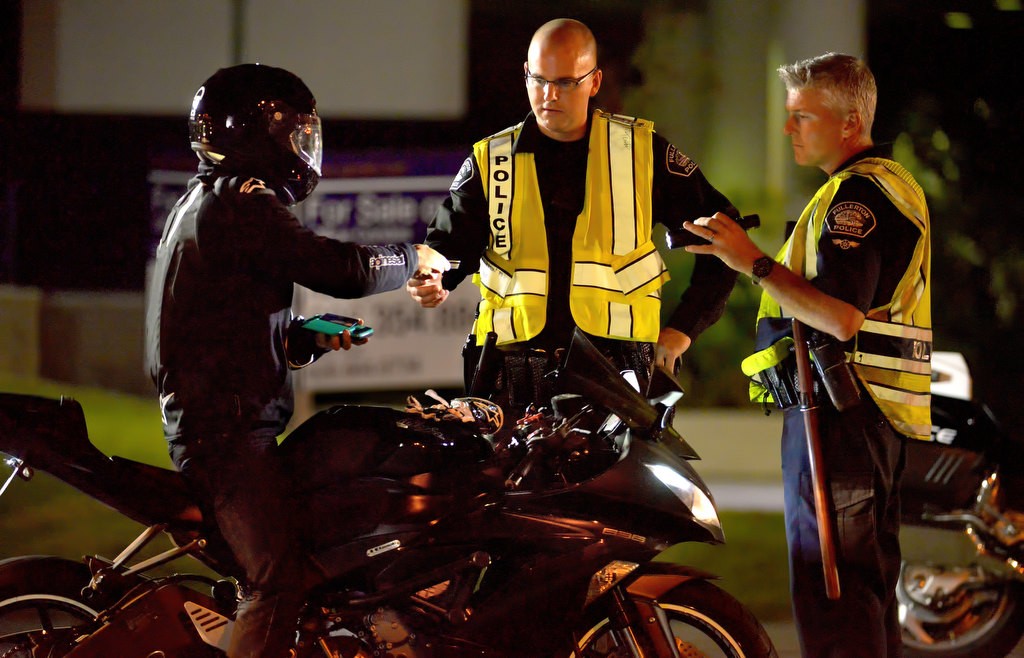 Officers Scott Flynn and Chris LeFave speak with a driver during the DUI Checkpoint. Photo by Steven Georges/Behind the Badge OC