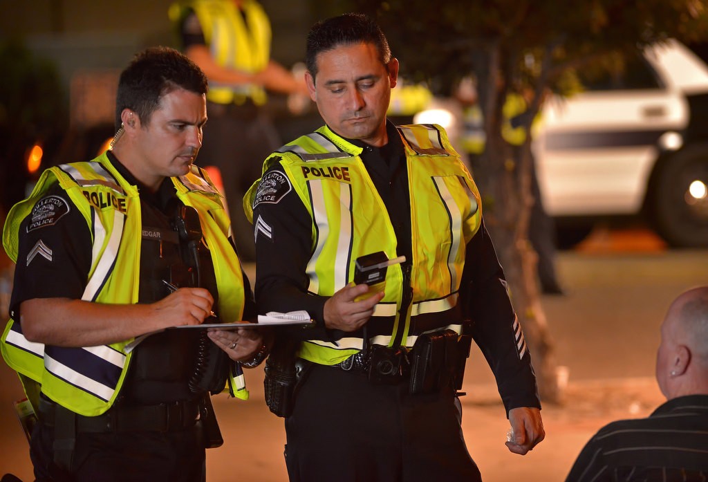 Fullerton PD Cpls. Kenny Edgar, left, and Joe Torres utilize a BAT to determine a driver’s Blood Alcohol Content (BAC). Photo by Steven Georges/Behind the Badge OC