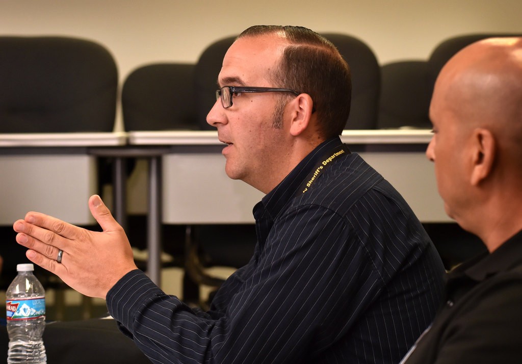 Gary Schade, assistant chief chaplain for the OC Sheriff’s Department, left, with Sam Barela during a meeting of local law enforcement chaplains at the OC Sheriff Coroner’s offices. Photo by Steven Georges/Behind the Badge OC