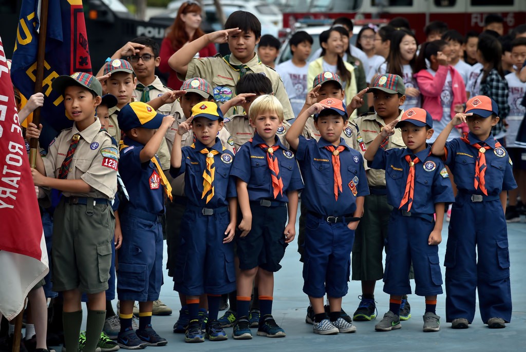 Boy Scouts and Cub Scouts from troop 1238 salute during the Pledge of Allegiance as they participate in a 9-11 assembly at Fisler Elementary School in Fullerton. Photo by Steven Georges/Behind the Badge OC