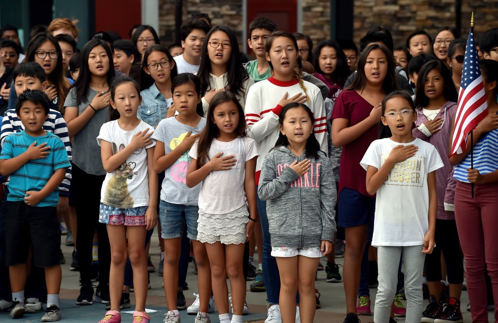 Kids from Fisler Elementary School stand for the Pledge of Allegiance as they participate in a 9-11 assembly at the school. Photo by Steven Georges/Behind the Badge OC