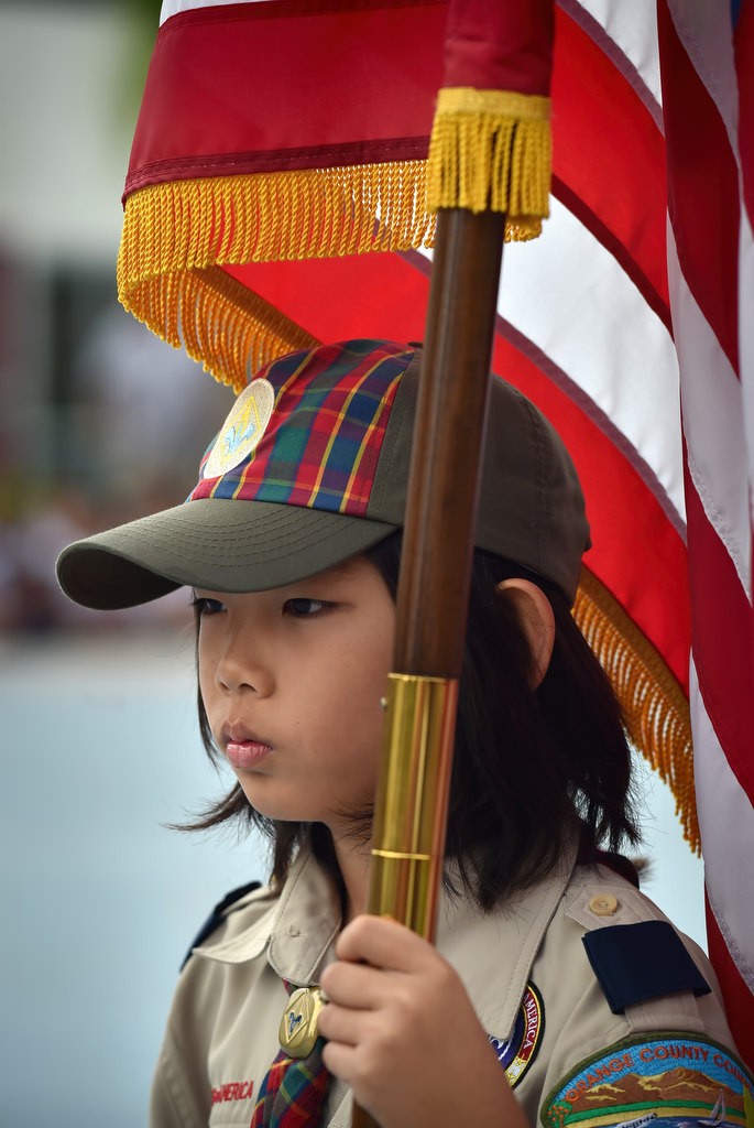 Evan Kim, 10, from Boy Scout troop 1238 holds the American flag during a 9-11 assembly at Fisler Elementary School. Photo by Steven Georges/Behind the Badge OC