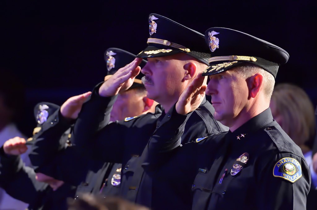 Anaheim police officers, including Anaheim PD Deputy Chief Dan Cahill, left, salute as the colors are posted during Anaheim’s 9-11 remembrance ceremony. Photo by Steven Georges/Behind the Badge OC
