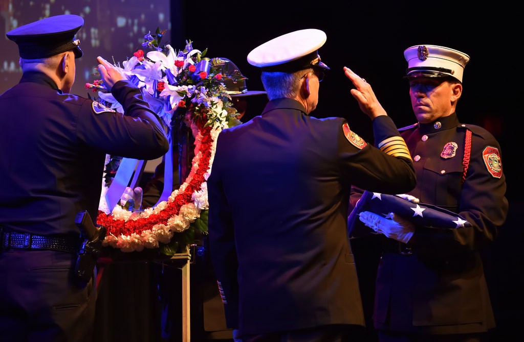 Anaheim Police Chief Raul Quezada, left, and Anaheim Fire and Rescue Chief Randy Bruegman salute during after the laying of the memorial wreath during Anaheim’s 9-11 remembrance ceremony at the City National Grove of Anaheim. Photo by Steven Georges/Behind the Badge OC