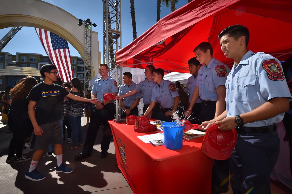 Anaheim Fire & Rescue Explorers hand out plastic fire hats and information about career opportunities at the conclusion of Anaheim’s 9-11 remembrance ceremony. Photo by Steven Georges/Behind the Badge OC