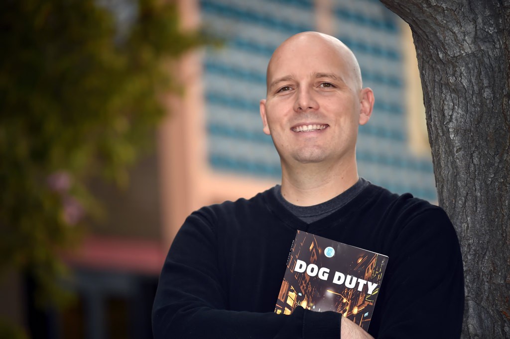 Bobby Lux, who wrote the book Dog Duty, works at Garden Grove PD as a police dispatcher. Photo by Steven Georges/Behind the Badge OC