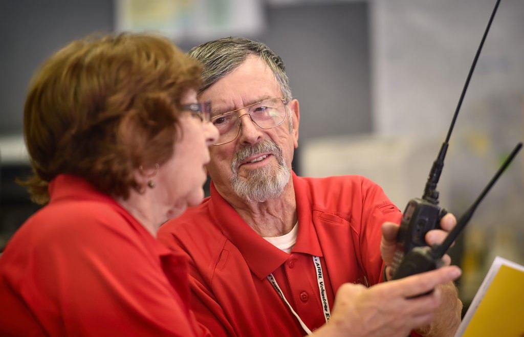 Anaheim Fire & Rescue’s CERT/RACES volunteers Judy Huitt, left, and Norman Todd help each other setup the frequencies on their portable radios in preparation for the upcoming drill. Photo by Steven Georges/Behind the Badge OC