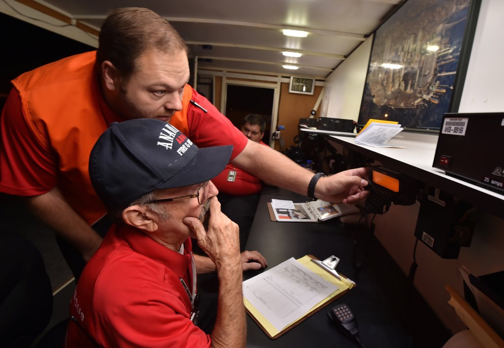 Anaheim Fire & Rescue’s CERT/RACES volunteers Daniel Jacobsen and Norman Todd, sitting, setup the radios during a drill inside Anaheim’s Volunteer Communication Unit, a portable trailer complete with its own optional power generator. Photo by Steven Georges/Behind the Badge OC