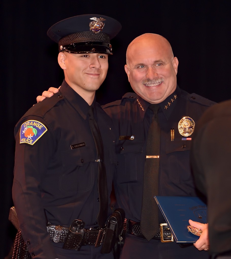 Orange Police Chief Tom Kisela, right, presents Recruit Anthony Castaneda with his diploma during the Golden West College Criminal Justice Training Center graduation ceremony. Photo by Steven Georges/Behind the Badge OC
