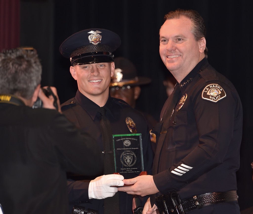 La Habra Police Chief Jerry Price, right, presents La Habra Officer Nicholas McDermott with Golden West College Criminal Justice’s Firearms Proficiency award during Golden West College Criminal Justice’s graduation ceremony. Photo by Steven Georges/Behind the Badge OC