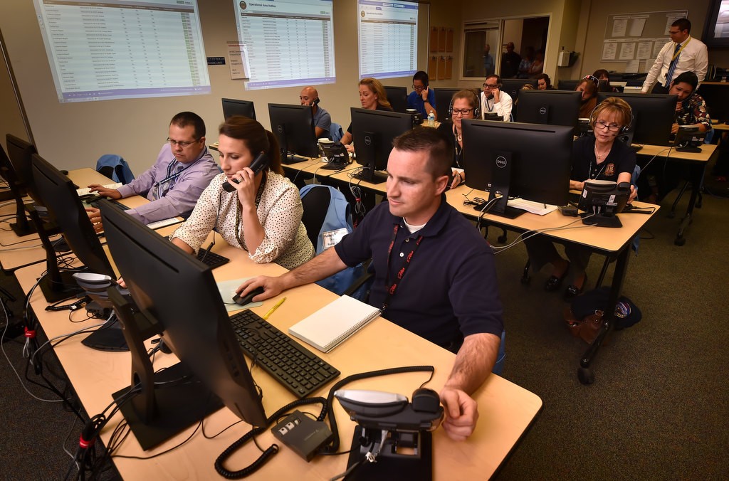 Dispatchers and other emergency personal take phone calls at the Orange County Emergency Operations Center (EOC) on Loma Ridge during a test of the AlertOC system. Photo by Steven Georges/Behind the Badge OC