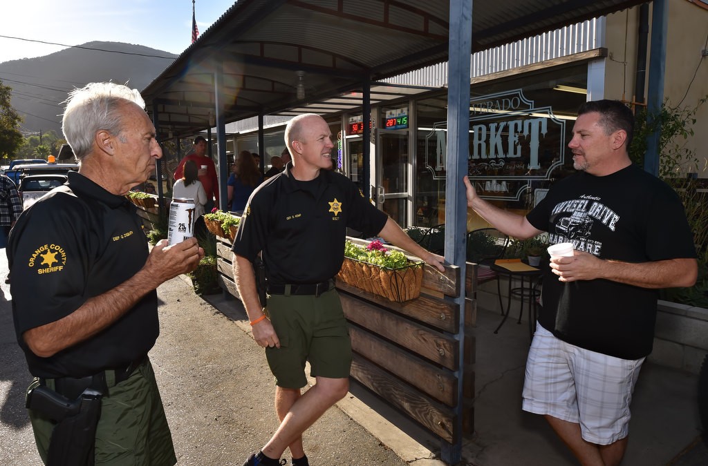 OC Sheriff Dep. Gary Ziebarth, left, and Dep. Devon Kemp talk to Silverado Canyon Market owner Jeff Hoagland as the OCSD hosts Coffee with a Cop. Photo by Steven Georges/Behind the Badge OC