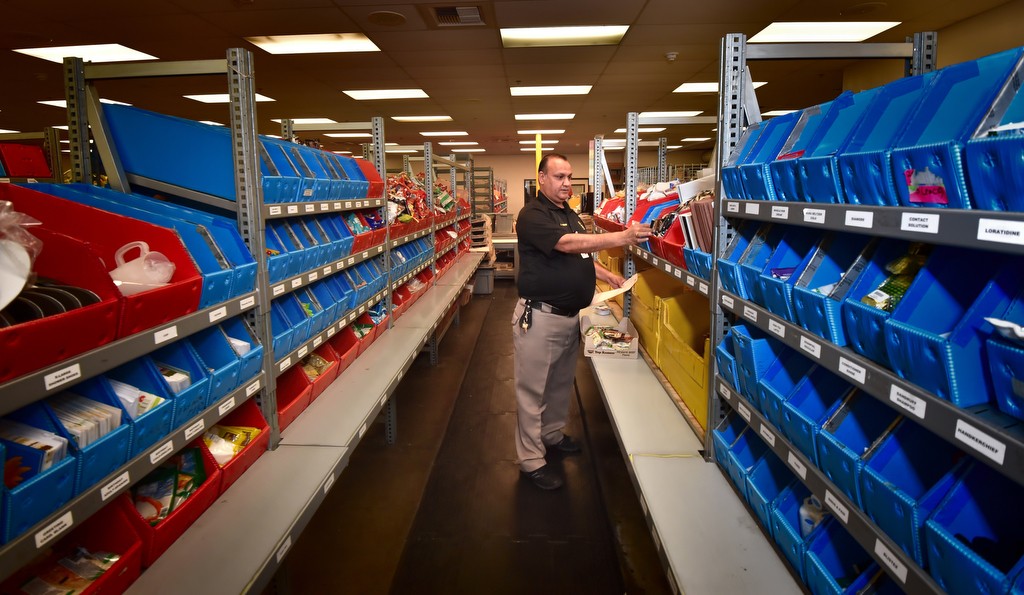 OCSD commissary worker Ashcan Kumar walks down the aisles as he fills orders from inmates in Orange County jails. Photo by Steven Georges/Behind the Badge OC
