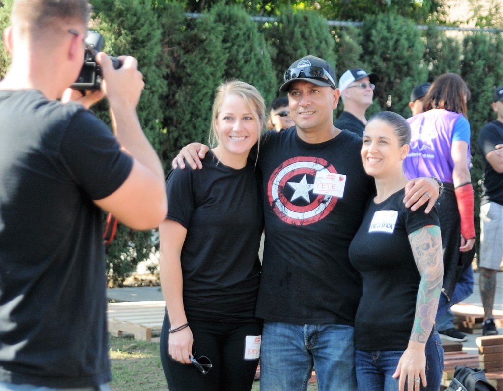 From left, OCSD deputies Kaylynn Cramer, Pete Chavez and Heather Drumond posed for a photo before the volunteer playground building project got underway at the Independencia Family Resource Center in Anaheim. Photo by Lou Ponsi/Behind the Badge OC
