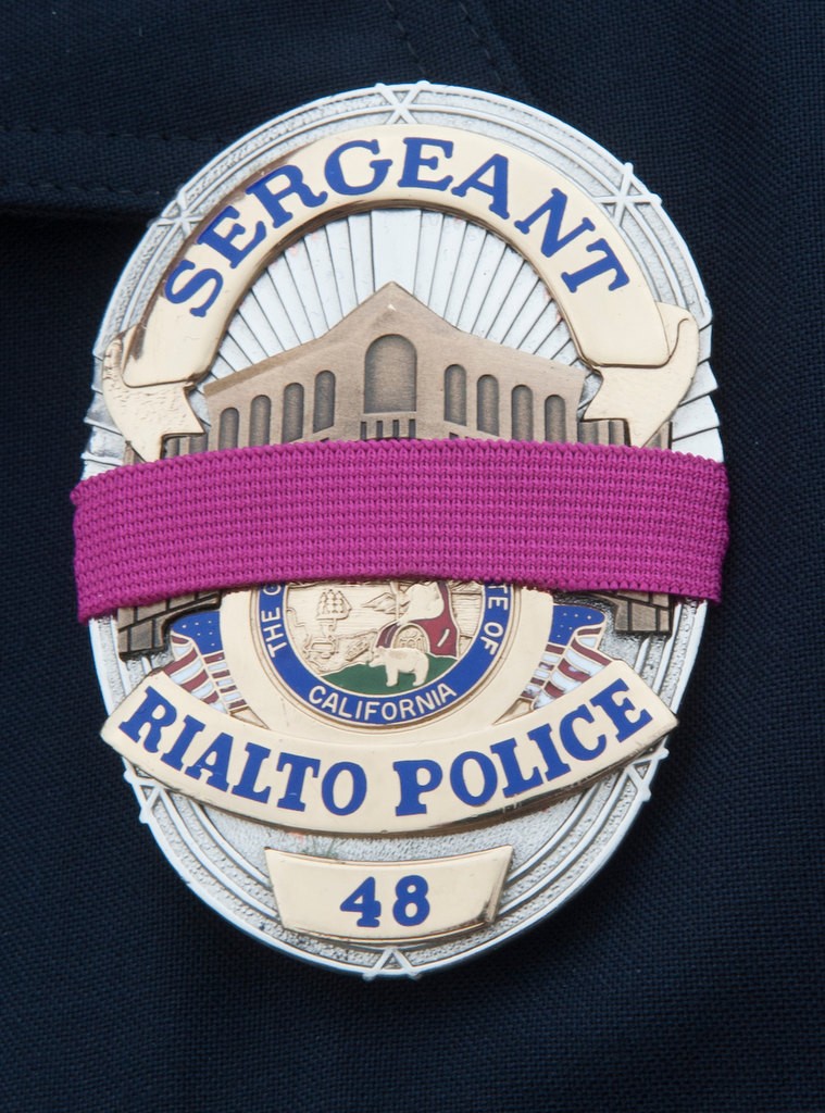Rialto Police badge with a pink stripe. About 40 Police Chiefs from various agencies in the state at Dodger Stadium to participate in the Pink Patch Project group photo