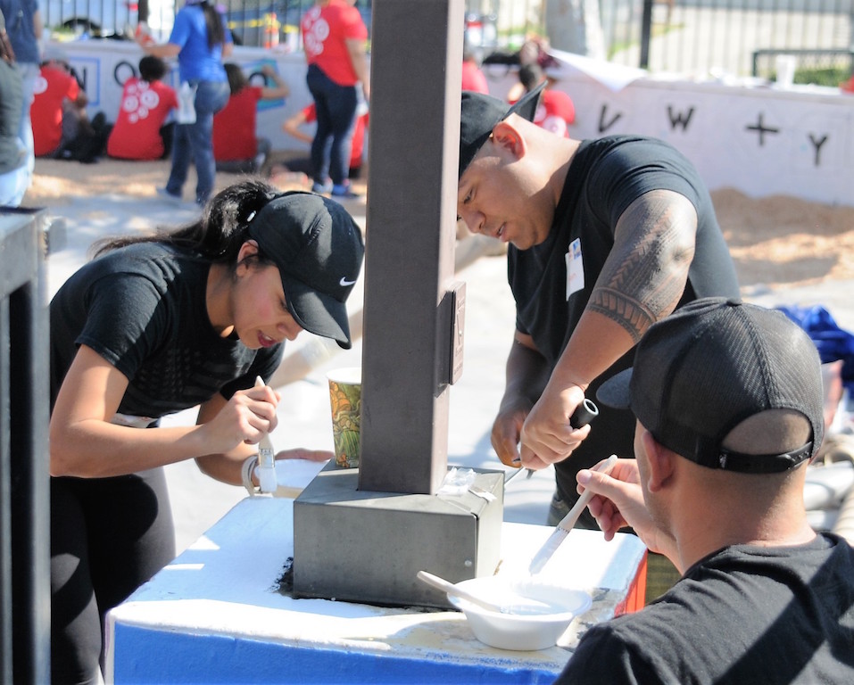 CSA Rebeca Flores and Dep. Adam Nauta of the OCSD took on painting duties and were among close to 40 OCSD employees who volunteered for a playground building project at the Independencia Family Resource Center in Anaheim. Photo by Lou Ponsi/Behind the Badge OC